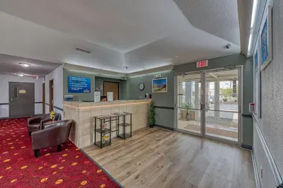 a lobby with a waiting area and a waiting room at American Inn & suites in Dundee
