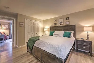 a bedroom with a large bed with green pillows at Single-Story Home in Fairborn with Yard and Patio! in Fairborn