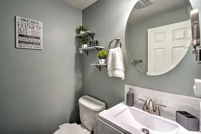 a bathroom with a sink and a mirror and a toilet at Single-Story Home in Fairborn with Yard and Patio! in Fairborn