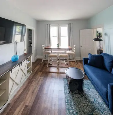 a living room with a blue couch and a table at Robin's Nest - Miami U, Weddings or Spooky Nook! in Hamilton