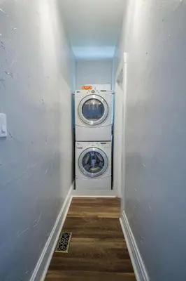 a washer and dryer in a room with a hallway at Robin's Nest - Miami U, Weddings or Spooky Nook! in Hamilton
