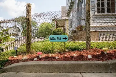 a garden with mushrooms and a sign in a yard at Robin's Nest - Miami U, Weddings or Spooky Nook! in Hamilton