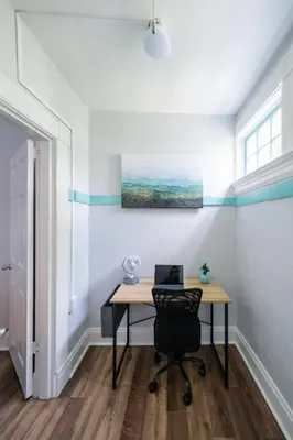 a desk with a laptop on it in a room at Robin's Nest - Miami U, Weddings or Spooky Nook! in Hamilton