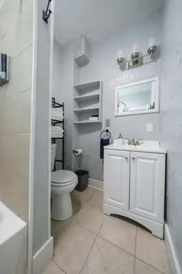 a white bathroom with a toilet and a sink at Robin's Nest - Miami U, Weddings or Spooky Nook! in Hamilton