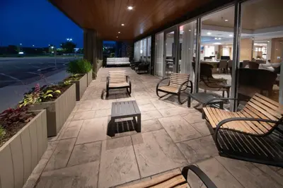 a patio with benches and tables on a building at Staybridge Suites - Cincinnati East - Milford by IHG in Cincinnati