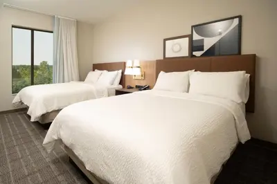 a hotel room with two beds and a window at Staybridge Suites - Cincinnati East - Milford by IHG in Cincinnati