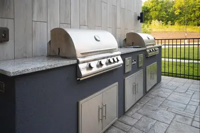 a row of barbecue equipment on a patio at Staybridge Suites - Cincinnati East - Milford by IHG in Cincinnati