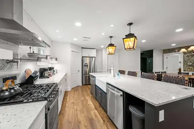 a large kitchen with white counter tops and appliances at Spacious Home Near Ark, Perfect for 12 Guests in Williamstown