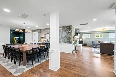 a dining room and living room with a table and chairs at Spacious Home Near Ark, Perfect for 12 Guests in Williamstown