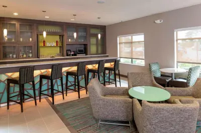 a lobby with a bar with chairs and tables at Residence Inn by Marriott Akron South/Green in Akron