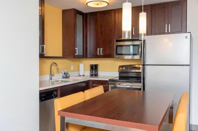 a kitchen with a wooden table and a white refrigerator at Residence Inn by Marriott Akron South/Green in Akron