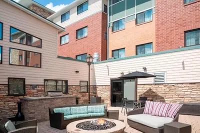 a patio with a fire pit in front of a building at Residence Inn by Marriott Akron South/Green in Akron