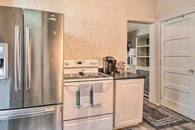 a kitchen with a stove and a refrigerator at Charming Fort Wayne Home about 1 Mi to Downtown! in Fort Wayne