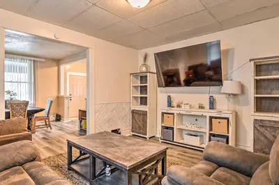 a living room with a couch and a table at Charming Fort Wayne Home about 1 Mi to Downtown! in Fort Wayne