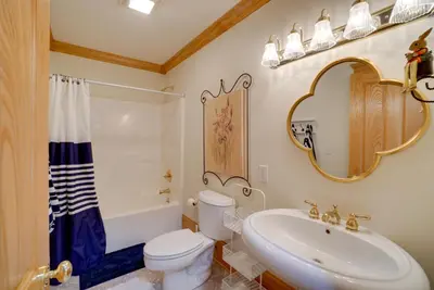 a bathroom with a sink toilet and a mirror at Spacious McArthur Home Private Hot Tub and Pond! in Hamden