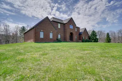 a large brick church on a grassy field at Spacious McArthur Home Private Hot Tub and Pond! in Hamden