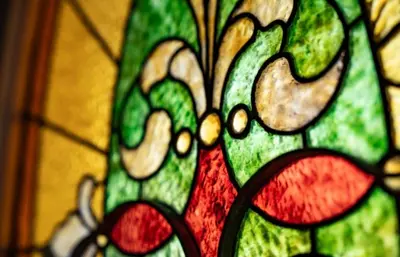 a stained glass window with a flower on it at The Victorian Guesthouse Bed & Breakfast in Delphos