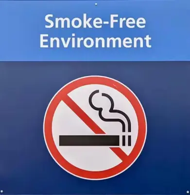 a sign that says smoke free environment with a cigarette at The Victorian Guesthouse Bed & Breakfast in Delphos