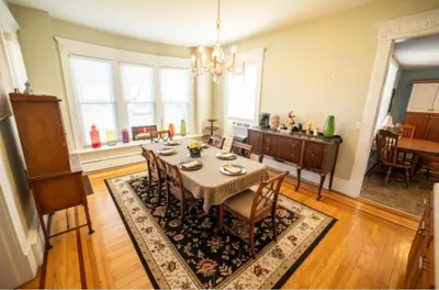 a dining room with a table and chairs in a room at The Victorian Guesthouse Bed & Breakfast in Delphos