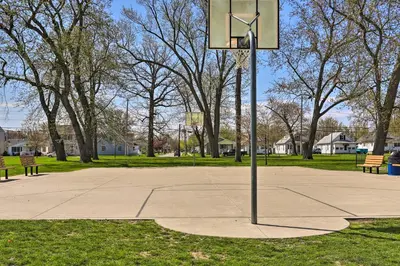 a basketball hoop in a park with two benches at Family-Friendly Port Clinton Home with Private Deck in Port Clinton