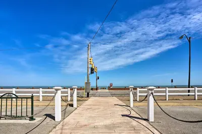 a boardwalk with a traffic light on the beach at Family-Friendly Port Clinton Home with Private Deck in Port Clinton