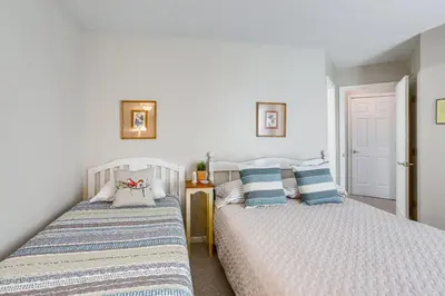 two beds sitting next to each other in a bedroom at Family-Friendly Port Clinton Home with Private Deck in Port Clinton
