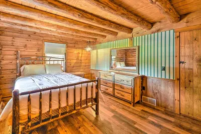 a bedroom with a bed and a television in a cabin at Rustic Zanesville Getaway with Expansive Yard! in Zanesville
