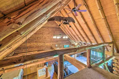 an overhead view of a wooden attic with a ceiling fan at Rustic Zanesville Getaway with Expansive Yard! in Zanesville