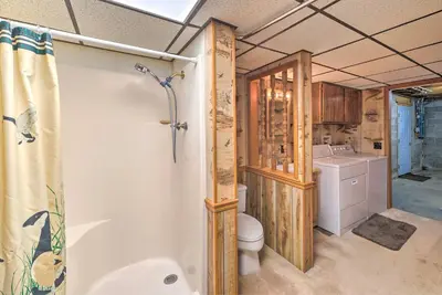 a bathroom with a tub and a toilet and a sink at Rustic Zanesville Getaway with Expansive Yard! in Zanesville