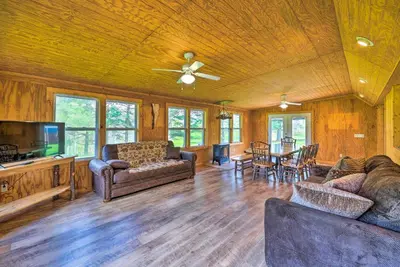 a living room with a couch and a tv and a table at Rustic Zanesville Getaway with Expansive Yard! in Zanesville
