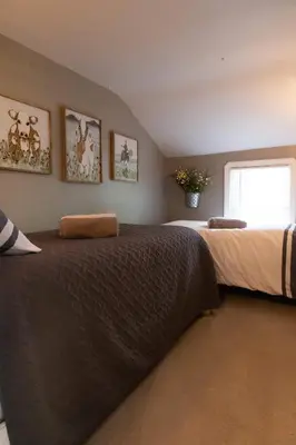 a bedroom with two beds and a window at The Carriage House 1836 in Millersburg