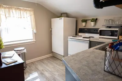 a kitchen with a white refrigerator and a stove at The Carriage House 1836 in Millersburg