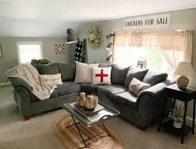 a living room with a gray couch with a cross pillow at The Carriage House 1836 in Millersburg