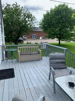 a deck with chairs and a bench on a house at Cherry717 in Fairborn