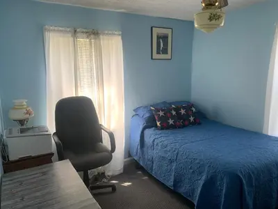 a bedroom with a bed and a chair and a desk at Cherry717 in Fairborn