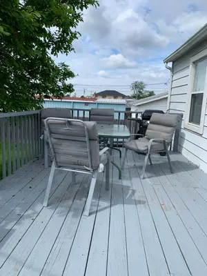 a patio with two chairs and a table on a deck at Cherry717 in Fairborn