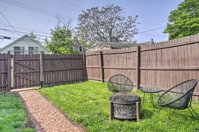 a backyard with two chairs and a fence at Blue Yonder Half Mi to Childrens Hospital in Columbus