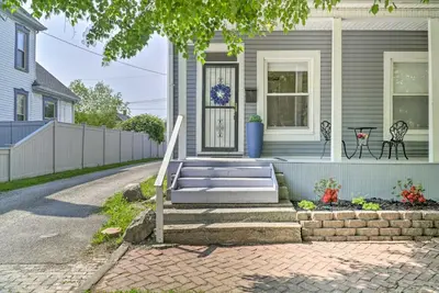 a house with a porch with a bench in front of it at Blue Yonder Half Mi to Childrens Hospital in Columbus