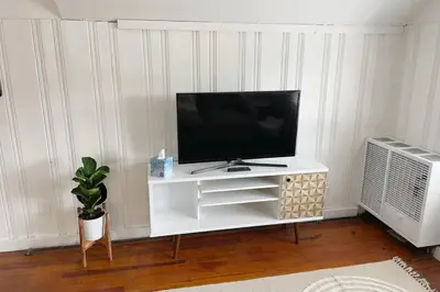 a flat screen tv sitting on a white entertainment center at Grandma's Attic in Lakewood