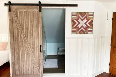 a sliding door in a room with a bedroom at Grandma's Attic in Lakewood