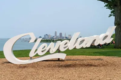 a sign in a park with a city in the background at Grandma's Attic in Lakewood