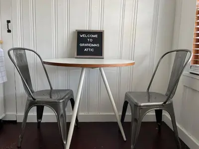 a table and two chairs with a sign on it at Grandma's Attic in Lakewood