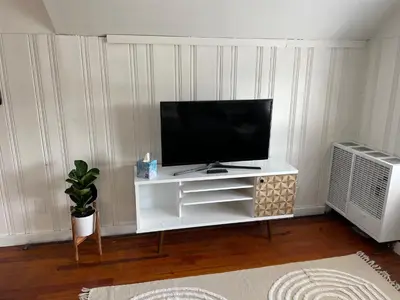 a living room with a television on a white entertainment center at Grandma's Attic in Lakewood