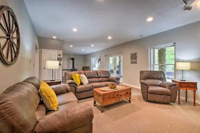 a living room with leather couches and a table at The Red Pine Cabin with Private Pond and Dock! in Loudonville