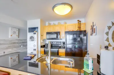 a kitchen with a sink and a black refrigerator at Cozy Lakefront Middle Bass Retreat with Balcony in Put-in-Bay