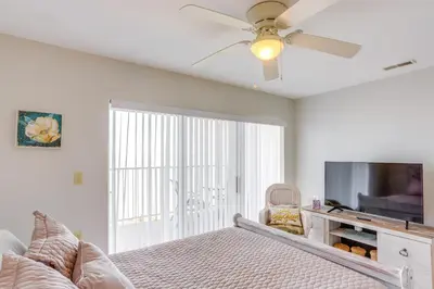 a bedroom with a bed and a flat screen tv at Cozy Lakefront Middle Bass Retreat with Balcony in Put-in-Bay