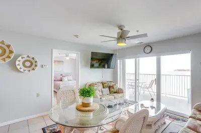 a living room with a glass table and chairs at Cozy Lakefront Middle Bass Retreat with Balcony in Put-in-Bay