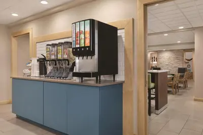 a lobby with a counter with a coffee shop at Country Inn & Suites by Radisson, Fairborn South, OH in Fairborn