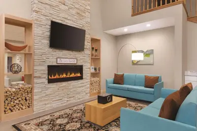 a living room with a couch and a fireplace at Country Inn & Suites by Radisson, Fairborn South, OH in Fairborn