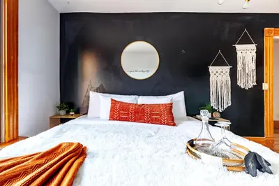 a bedroom with a large bed with a black wall at Jungle House Luxury Homes - Columbus Downtown Short North - Walk to Convention Center & Nationwide Arena - Sleeps up to 10 - Free Parking - Over 5,800 Five Stars in Columbus